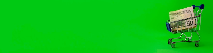 Foto carrinho de compras de banner com notas de 50 dólares em um fundo verde