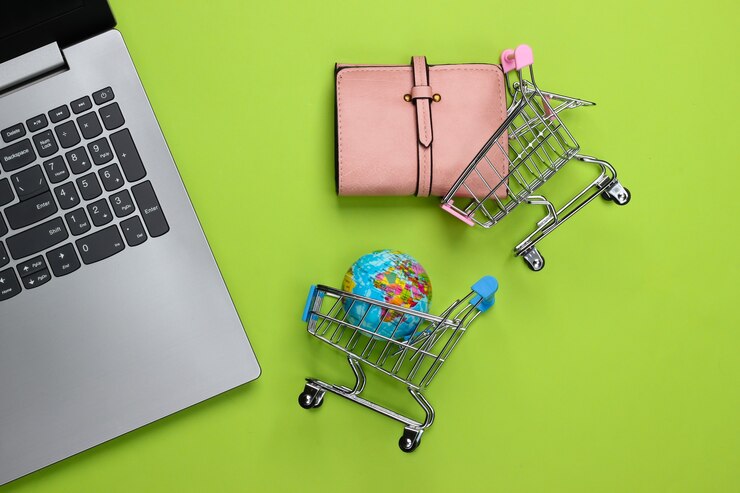Foto carrito de la compra con globo, billetera, portátil en verde