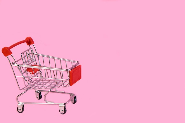 Carrito de compras carrito vacío sobre fondo rosa Promociones ventas compras