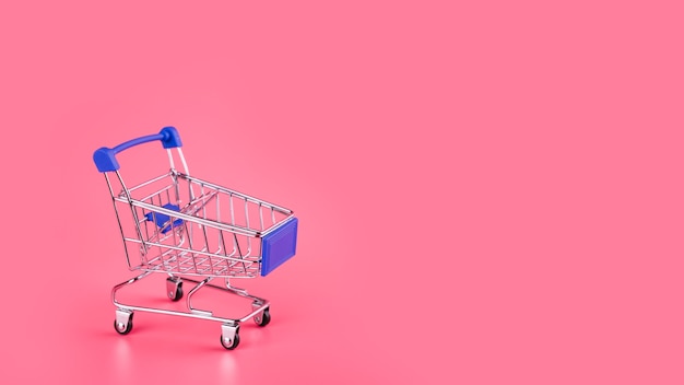 Carro de compras azul vacío en el contexto rosado