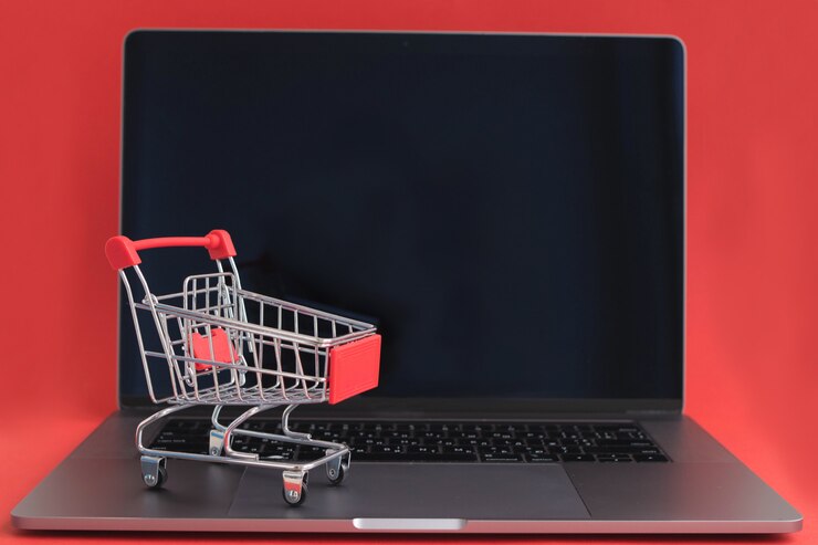 Foto carro de compras en la computadora portátil