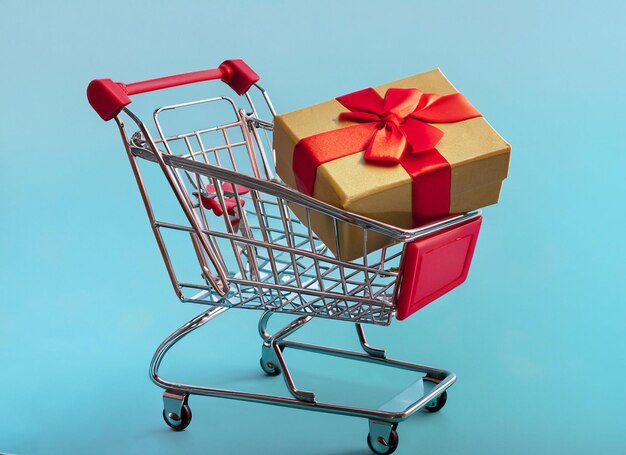 Carro de compras con fondo de caja de regalo