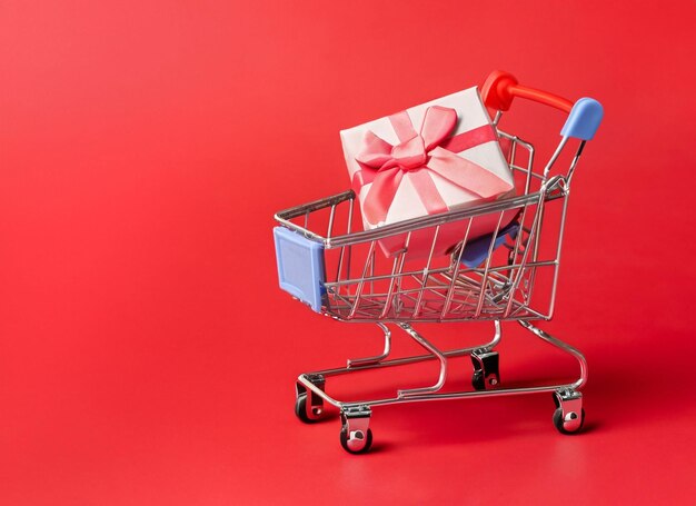 Carro de compras con fondo de caja de regalo