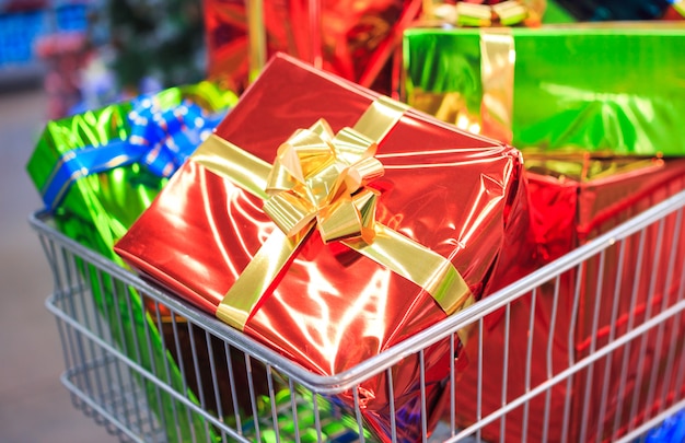 Carro de compras con regalos en supermercado