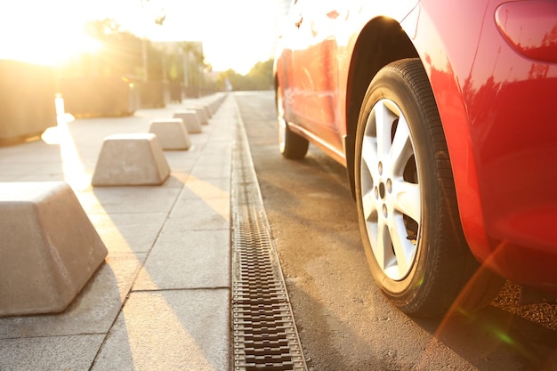 Carro vermelho moderno ao ar livre em closeup de dia ensolarado