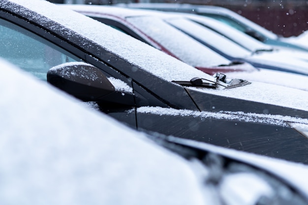 Carros cobertos de neve no estacionamento