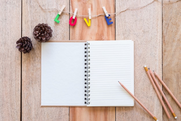 Foto carta de amor de san valentín con el cuaderno sobre fondo de tablero de madera con espacio de copia.