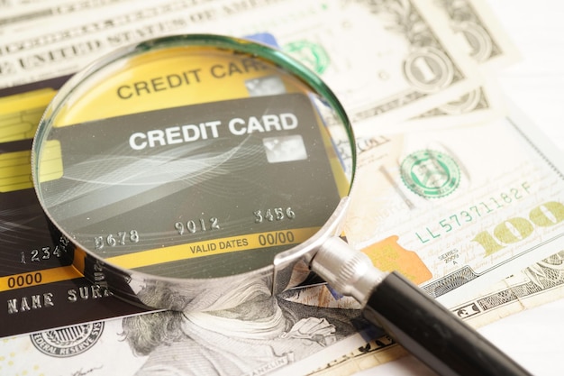 Cartão de crédito e lupa para o conceito de negócios de finanças de segurança de compras on-line