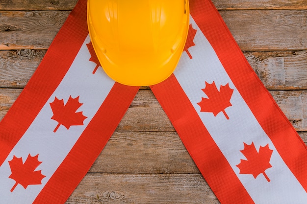 Foto cartão de feliz dia do trabalho de canadá e capacete amarelo