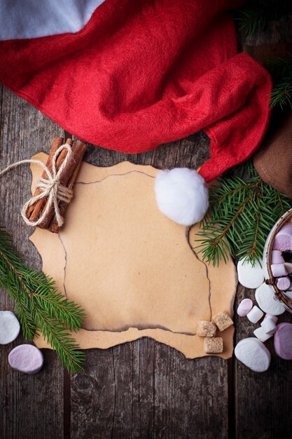 Cartão de papel vazio e chapéu de papai noel vermelho. foco seletivo, vista superior, espaço para texto