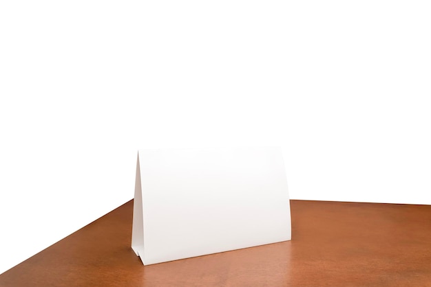 Cartão de tenda de folha de papel branco na mesa de madeira fundo branco isolado pode inserir caminho de recorte de mensagem do cliente Cartão de menu de quadro de maquete de suporte