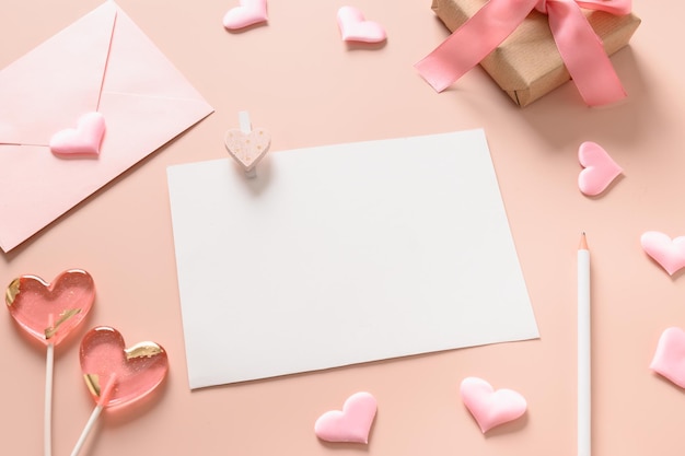 Cartão em branco de Dia dos Namorados para carta de amor e envelope rosa presente pirulitos como coração em fundo rosa Copiar espaço Fechar