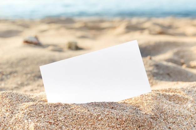 Cartão em branco na areia da praia