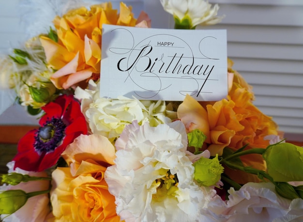 Foto cartão postal banner da internet com uma saudação de aniversário com a inscrição feliz aniversário um buquê