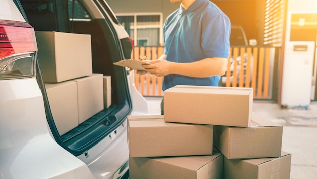 Carteiro tailandês verificando pacotes e caixas de correio para entrega em domicílio. serviço asiático de compras online.