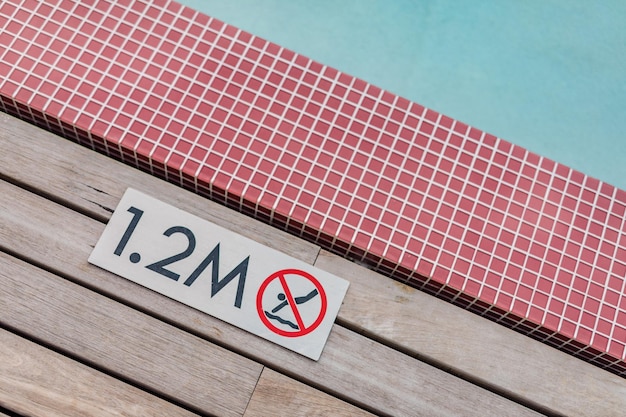 Foto cartel que muestra 1,2 metros de profundidad en el borde de la piscina azul sin señal de advertencia de buceo
