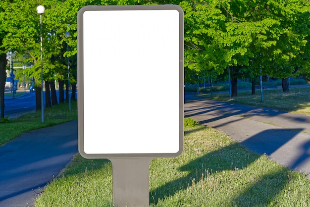 Cartelera en blanco para publicidad exterior sobre un fondo de naturaleza verde