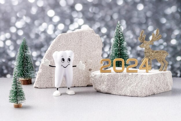 Foto cartoon-modell eines zahns mit den zahlen 2024 und einem weihnachtshirsch und weihnachtsbäumen