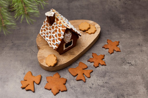 Casa de pão de gengibre com biscoitos Fechar a foto da doce sobremesa caseira com decoração de glacê em cinza