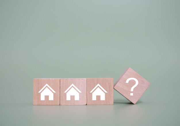 Casa em miniatura com ícones de ponto de interrogaçãoO conceito de escolher uma casa adequada para planejar a vida no futuro Imóveis