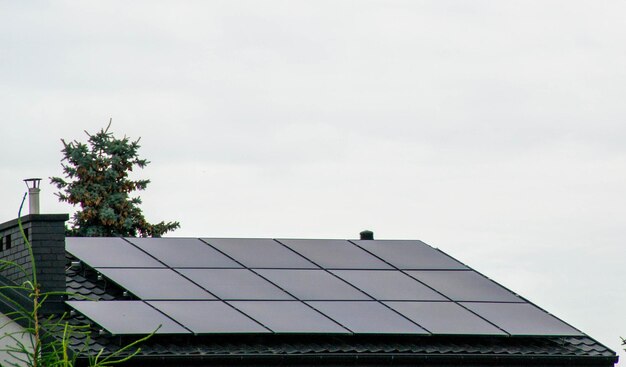 Casa de granja histórica con paneles solares modernos en el techo y la pared