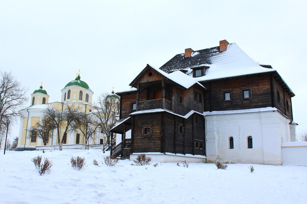 La casa de madera y la hermosa iglesia en invierno