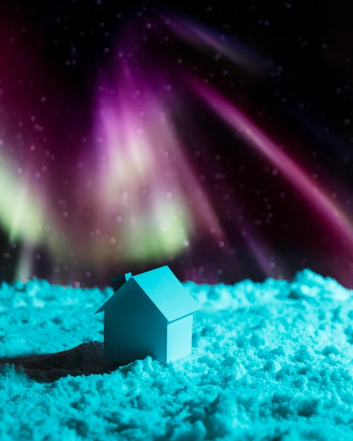 Foto casa na neve com aurora boreal