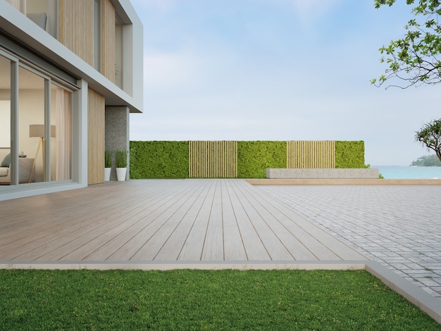 Casa de playa con terraza de madera cerca del piso de adoquines vacío para estacionamiento