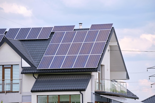 Casa residencial con techo cubierto con paneles solares fotovoltaicos para la producción de energía eléctrica ecológica limpia en una zona rural suburbana Concepto de casa autónoma