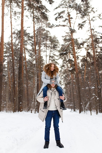 casal adorável caminhando na floresta de inverno