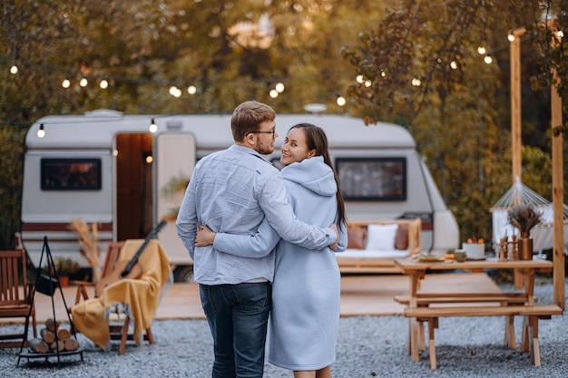 Casal apaixonado morando em trailer no camping e se divertindo e feliz