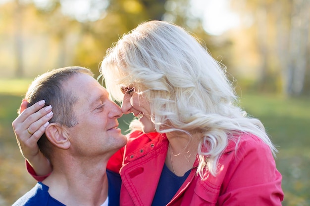 Casal apaixonado no parque outono Cônjuges de meia-idade para passear