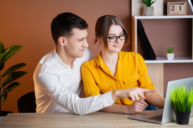 Foto casal apaixonado, trabalhando com sucesso juntos em seus próprios negócios no escritório