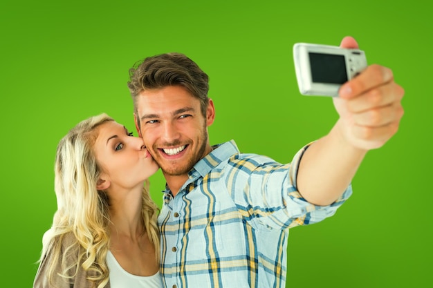 Casal atraente tirando uma selfie juntos contra a vinheta verde