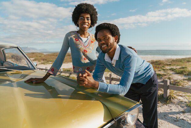 Foto casal de estilo retrô aguardando o tempo à beira-mar