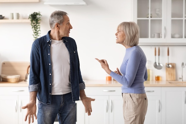 Casal de idosos discutindo com a esposa da cozinha gritando com o marido