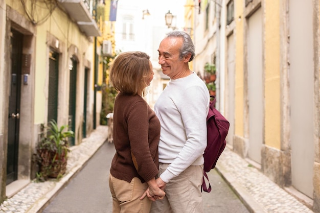 Casal de turistas maduros de mãos dadas compartilhando momentos de viagem em lisboa