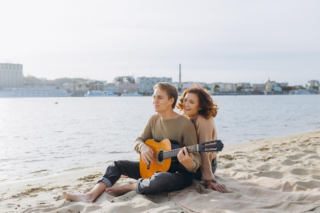Casal feliz apaixonado Retrato sensual deslumbrante de um jovem casal Jovem tocando violão para sua amada
