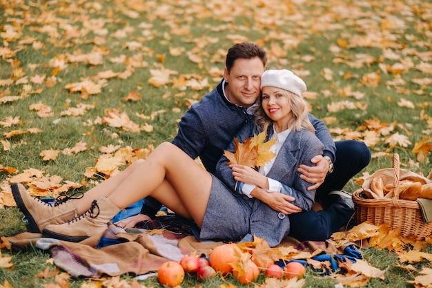 Casal feliz aproveitando a temporada de primavera de outono dourado no parque