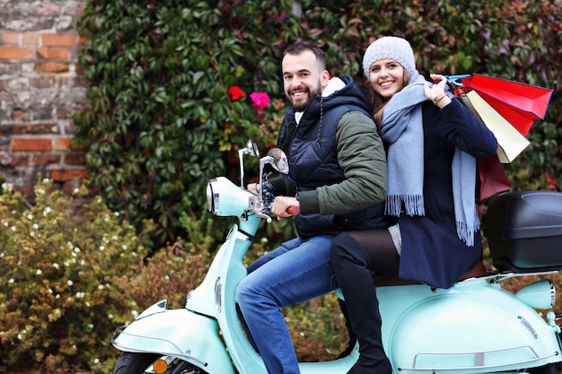 casal feliz com sacolas de compras depois de fazer compras na cidade, sorrindo e se abraçando