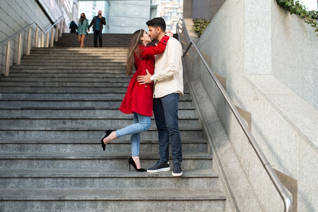 Casal feliz se beijando em uma escada