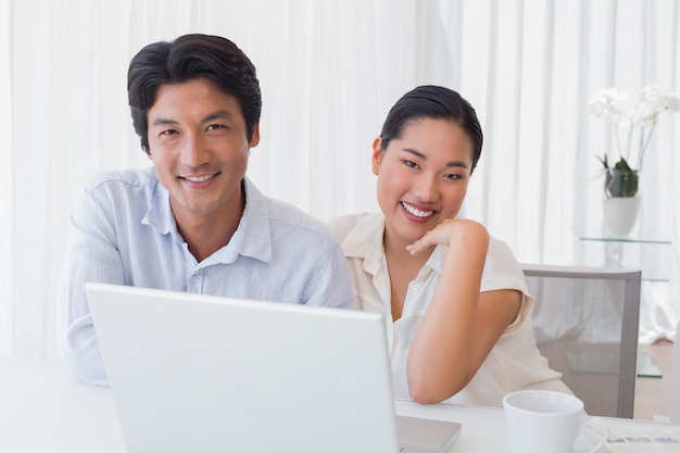 Casal feliz usando laptop juntos