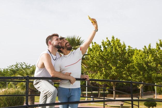 Casal gay tirando uma foto com seu celular