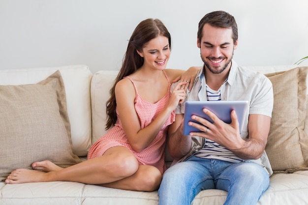 Casal Hipster usando um tablet no sofá