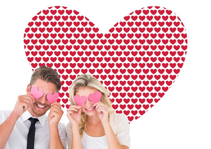 Foto casal jovem atraente segurando corações rosa sobre os olhos contra o padrão de dia dos namorados