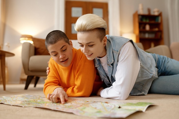 Casal jovem lgbt planejando viajar nos fins de semana escolhendo rota ou local de destino no mapa de papel