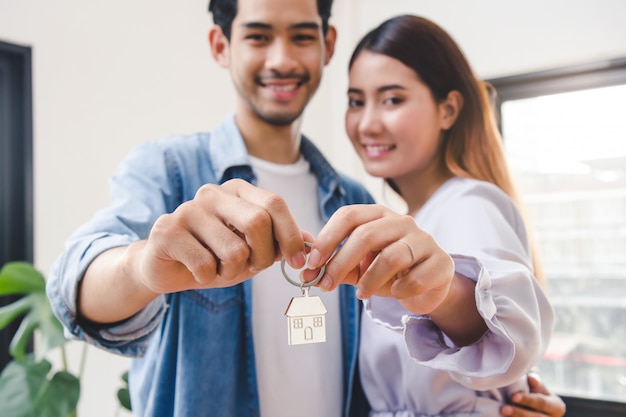 Casal mostrando chaves apartamento após a compra.