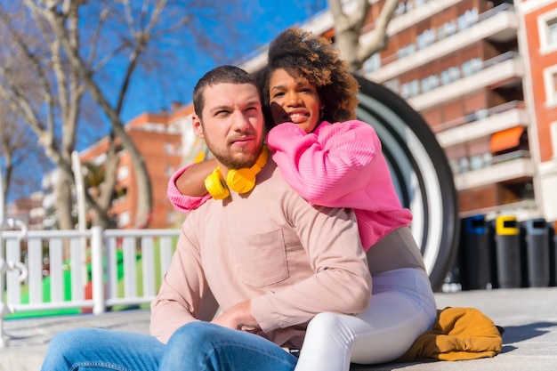 Casal multirracial nas ruas do estilo de vida da cidade se abraçando e olhando um para o outro