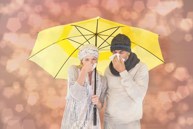 Casal na moda de inverno espirrando sob o guarda-chuva contra o padrão de design de pontos brilhantes de luz