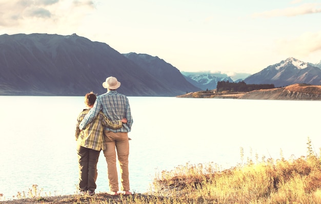 Casal no lago de belas montanhas, Nova Zelândia, Lago Tekapo